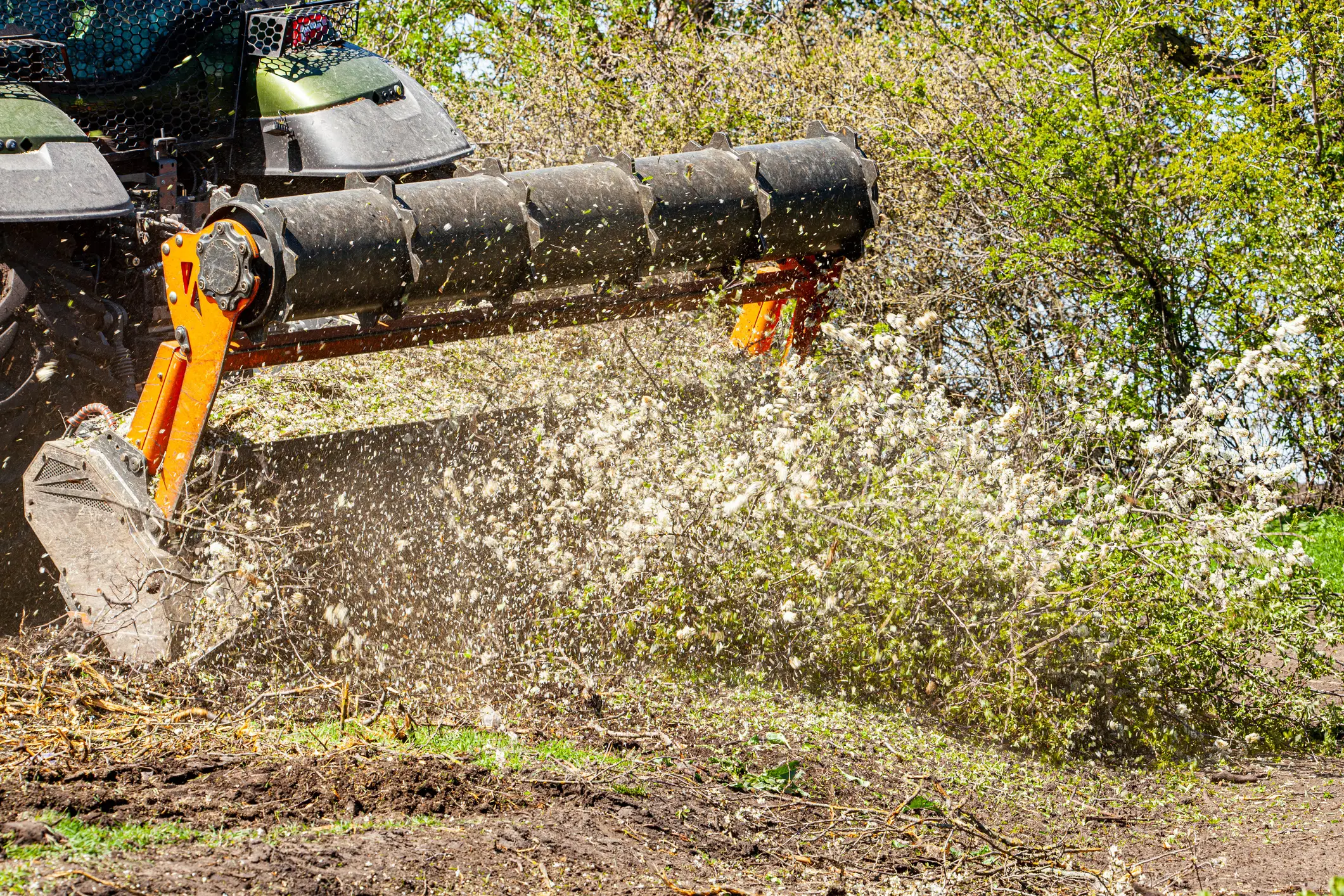 heavy machinery clearing trees on lot clearing job